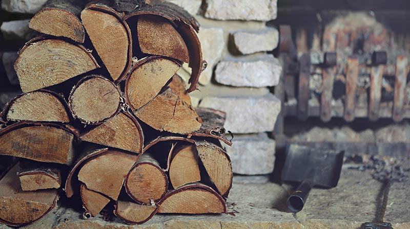 Firewood stacked by fireplace